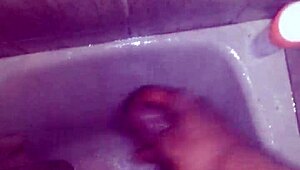 guy strokes his big black monster cock while showering and bathing until cum explodes