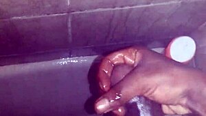 guy strokes his big black monster cock while showering and bathing until cum explodes