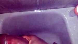 guy strokes his big black monster cock while showering and bathing until cum explodes