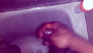 guy strokes his big black monster cock while showering and bathing until cum explodes