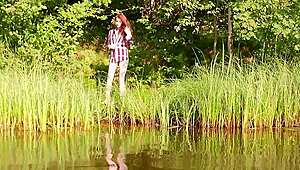 Wanna see this cute redhead beauty strip nude outdoors by the lake?