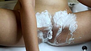 Watch trimmer buzz hairy pussy then razor with foam shaves it bald in steamy closeup