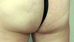 A humiliated guy with tiny cock sniffs panties while undressing slowly