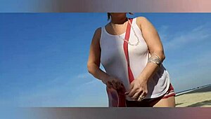 mature blonde with big natural tits and pussy lips solos sexy on the beach