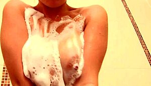 blonde strips and touches herself in shower