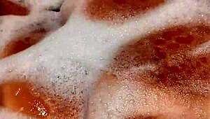 Tanned stepsister plays with big tits and pussy in bathroom