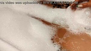 Tanned stepsister plays with big tits and pussy in bathroom
