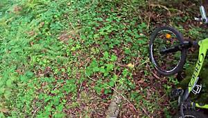 Girl cycling in woods helps with outdoor task