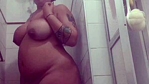 A pregnant brazilian milf shows body in shower